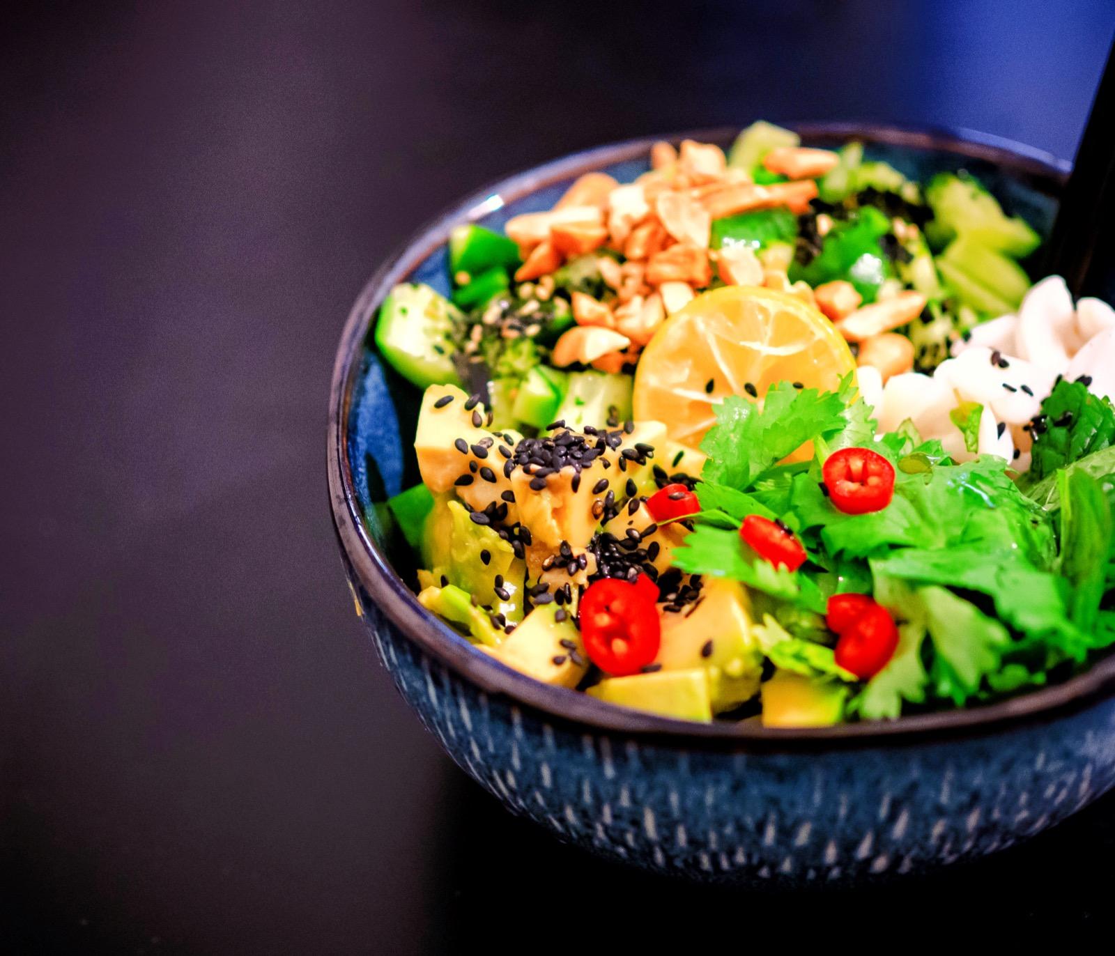 Een bowl met verse groenten, granen en kruiden